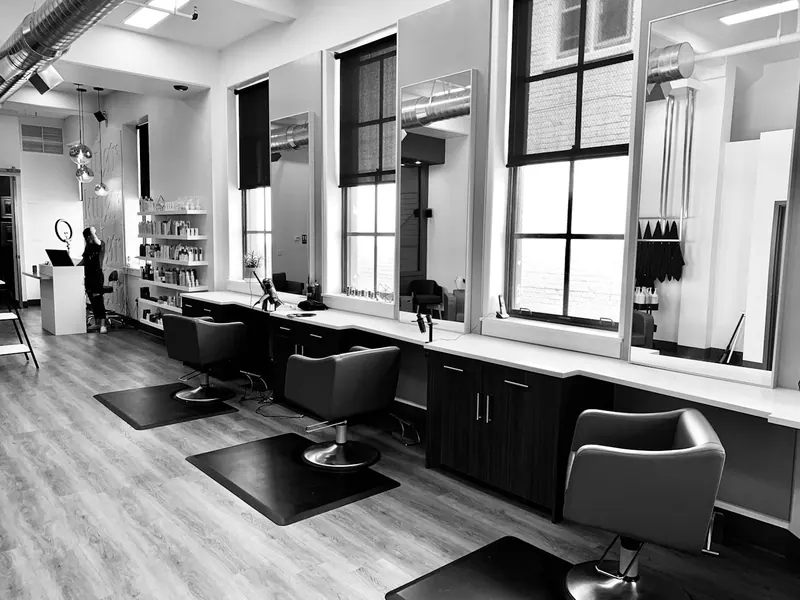 Black-and-white barber shop interior with chairs and mirrors